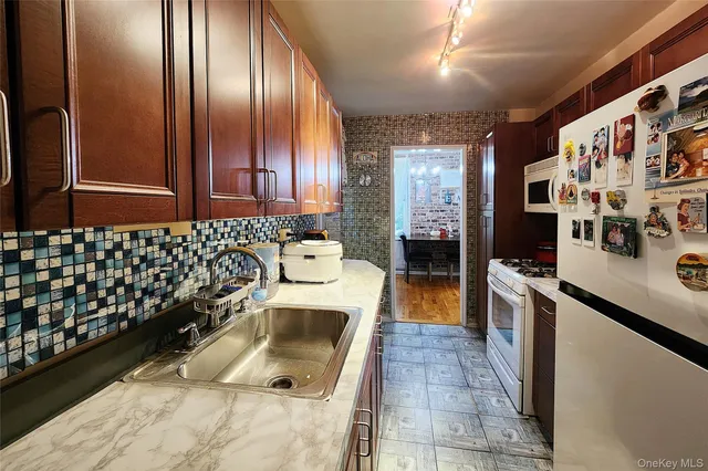 a kitchen with a sink a stove and refrigerator