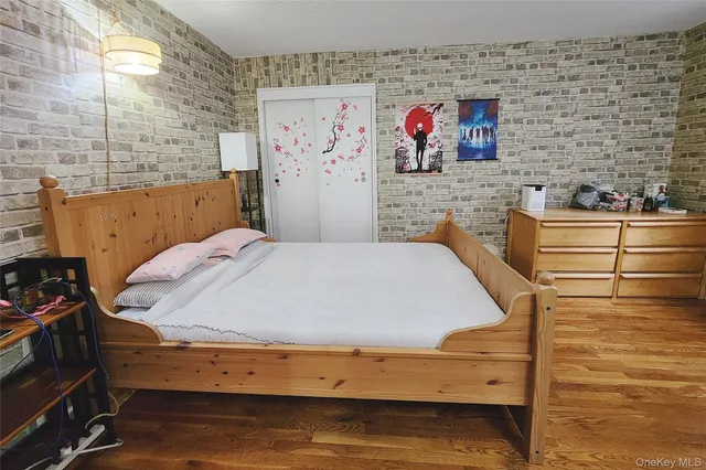 a living room with stainless steel appliances kitchen island granite countertop furniture a rug and a wooden floor