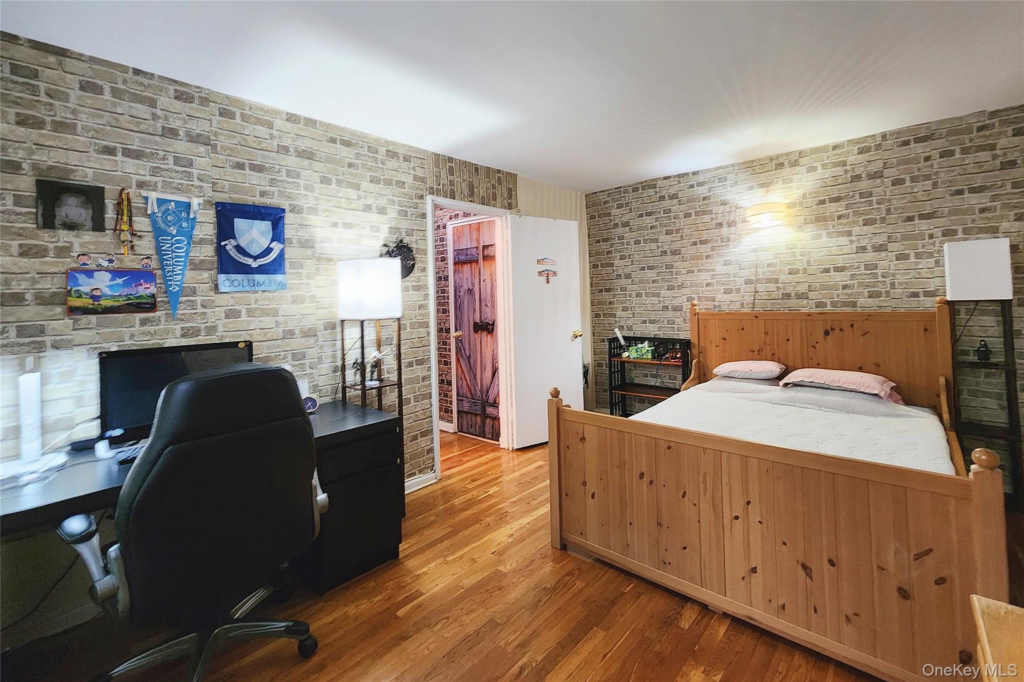 209-20 18th Avenue, Unit 5E Queens, NY 11360 - Photo 18 of 29 a bed room with a bed and a television