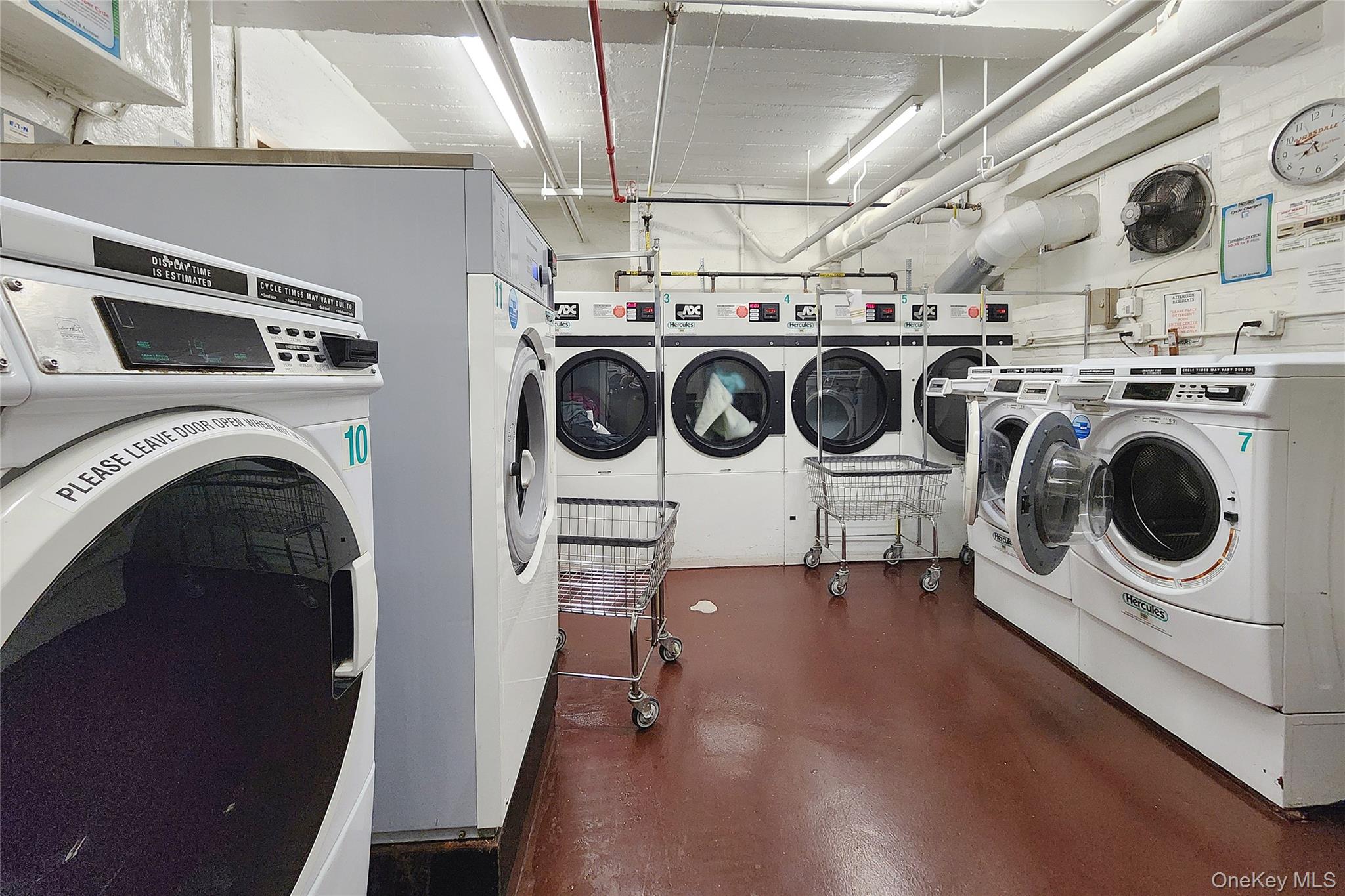 209-20 18th Avenue, Unit 5E Queens, NY 11360 - Photo 24 of 29 a utility room with dryer washer and a view of living room