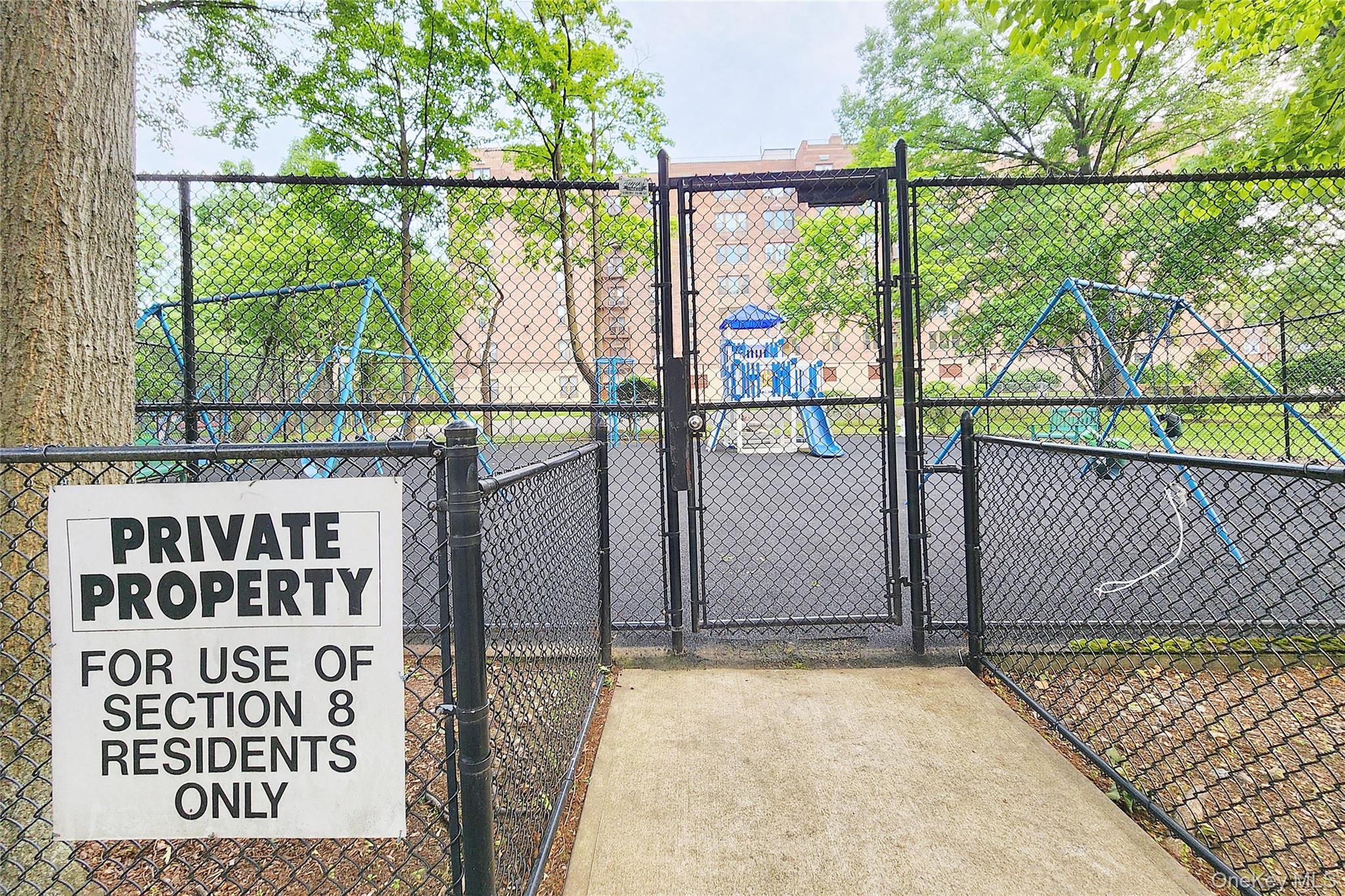 209-20 18th Avenue, Unit 5E Queens, NY 11360 - Photo 26 of 29 a view of a gate with a street sign on the wall