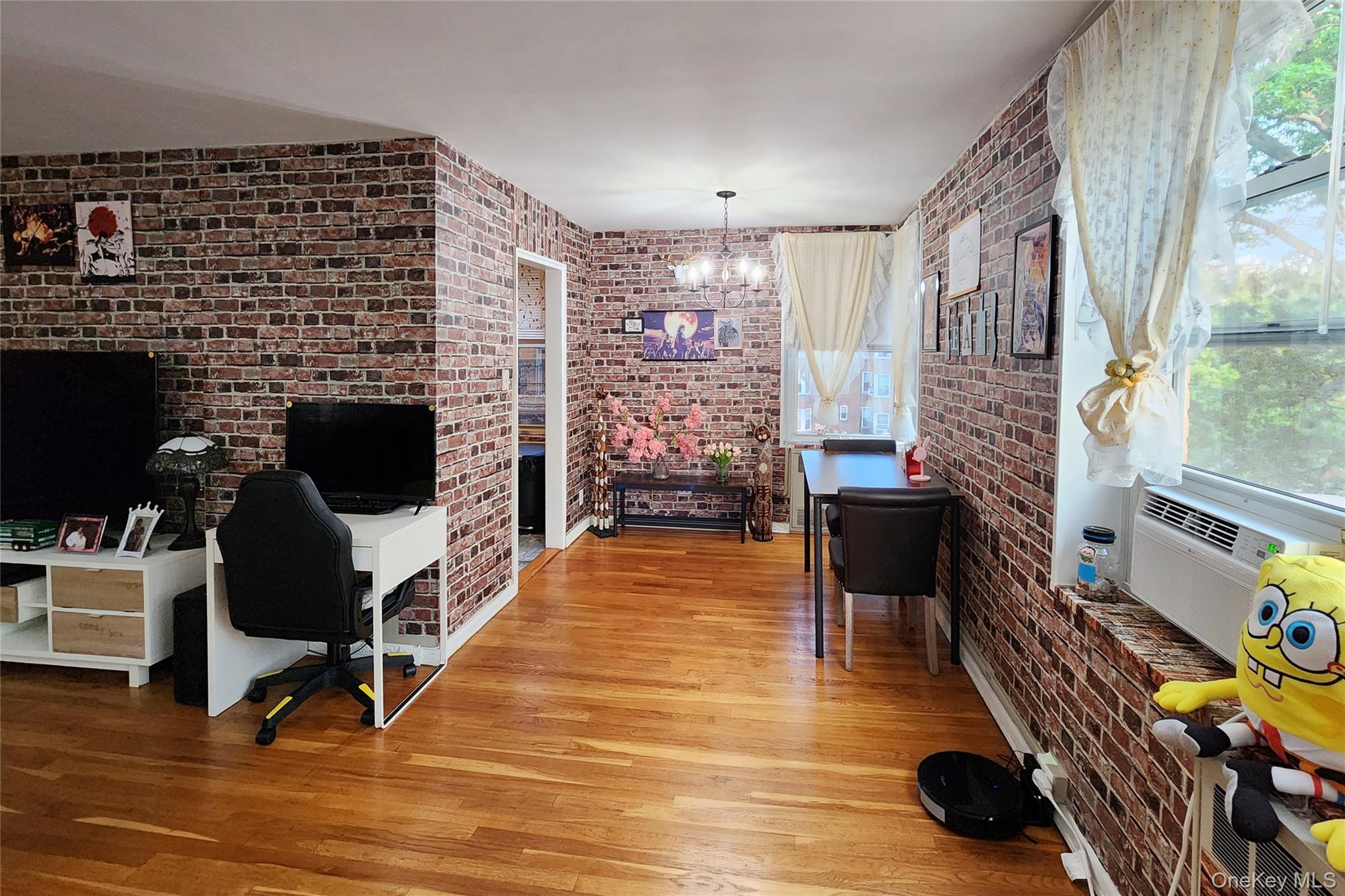 209-20 18th Avenue, Unit 5E Queens, NY 11360 - Photo 7 of 29 a living room with furniture and a fireplace