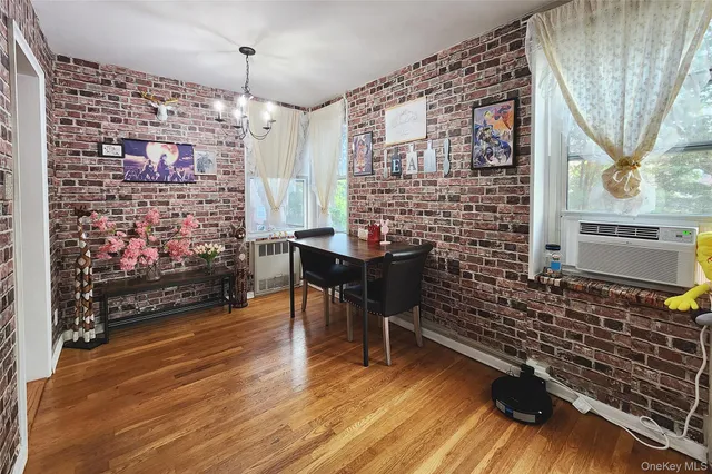 a dining room with furniture and wooden floor