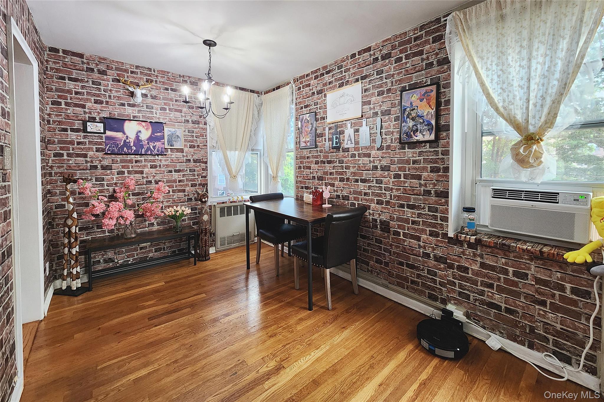 209-20 18th Avenue, Unit 5E Queens, NY 11360 - Photo 8 of 29 a livingroom with fireplace and wooden floor