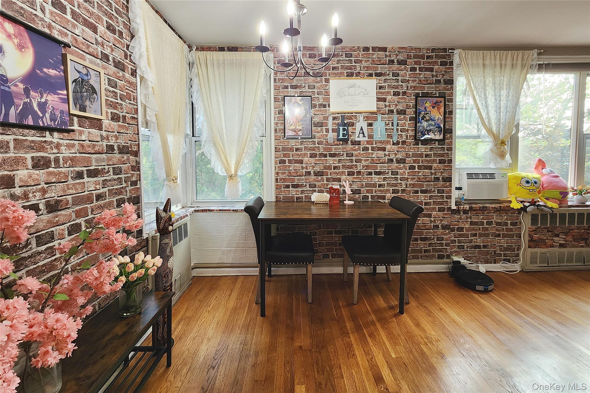 209-20 18th Avenue, Unit 5E Queens, NY 11360 - Photo 9 of 29 a dining room with furniture and wooden floor