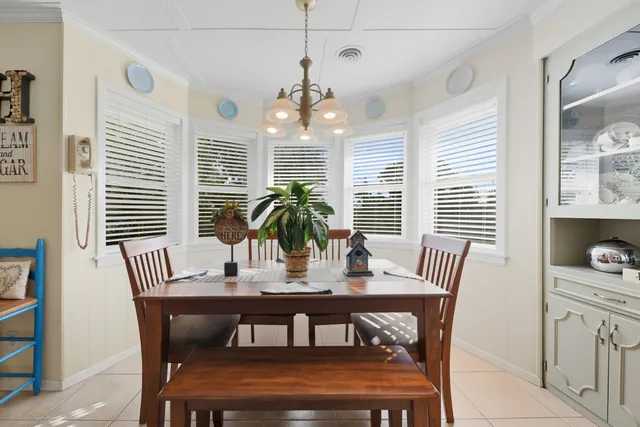a view of a dining room with furniture wooden floor and chandelier