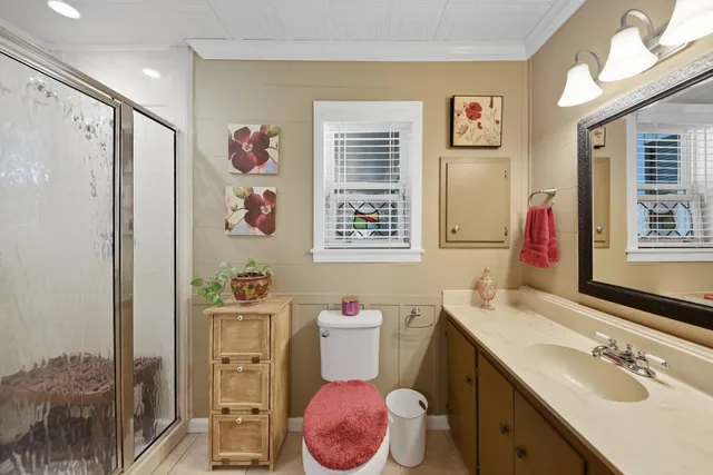 a bathroom with a sink mirror vanity and toilet