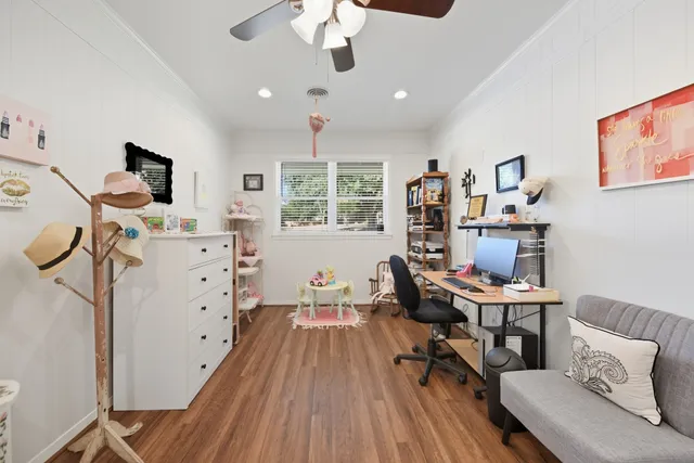a workspace with wooden floor and furniture