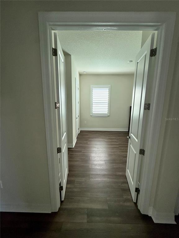 8441 Pk Clf Way Orlando, FL 32836 - Photo 46 of 59 a view of a hallway with wooden floor and stairs