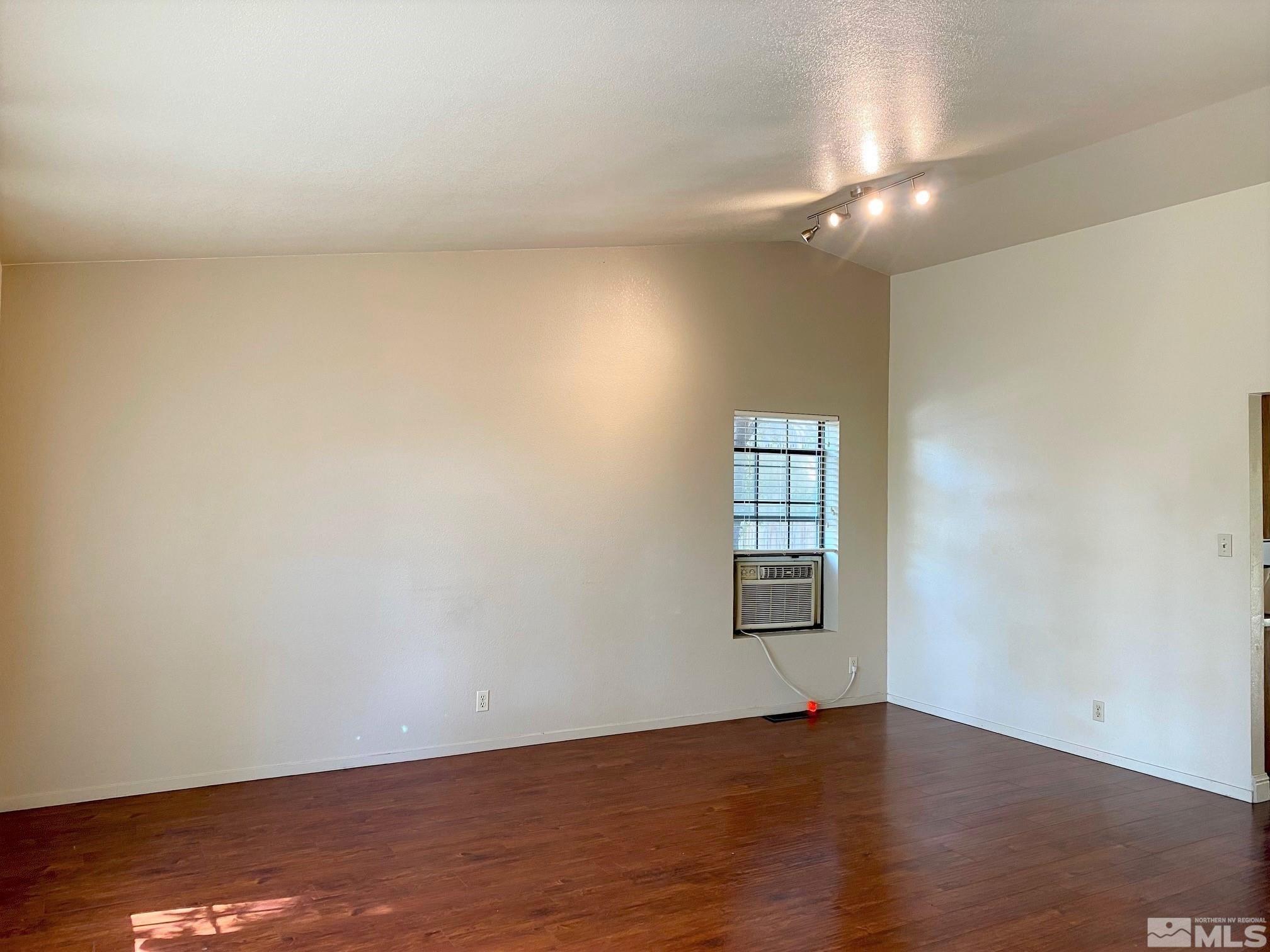 3870 West 7th Street Reno, NV 89503 - Photo 4 of 17 a view of an empty room with wooden floor and a window