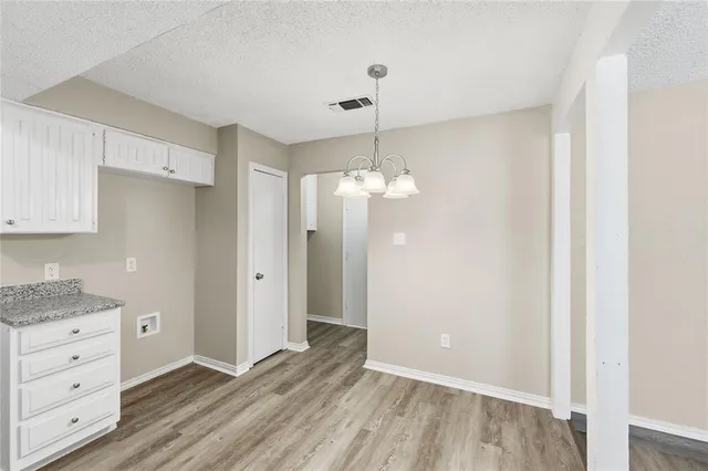 a view of kitchen cabinets and wooden floor