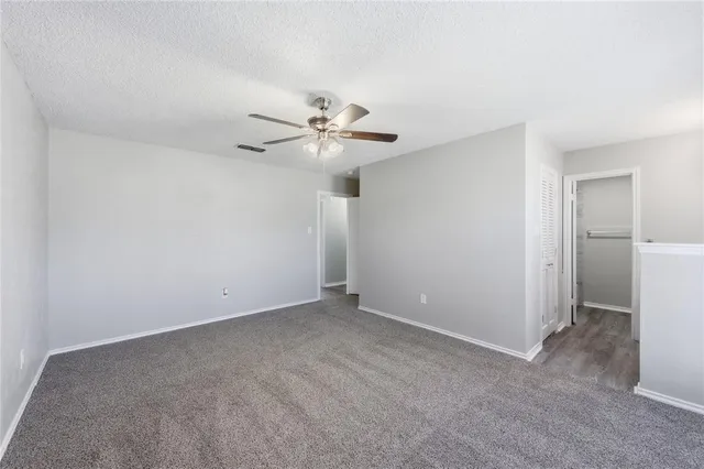 a view of a big room with closet and windows