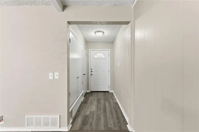 a view of a hallway with wooden floor