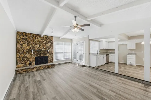 wooden floor in an empty room with a fireplace