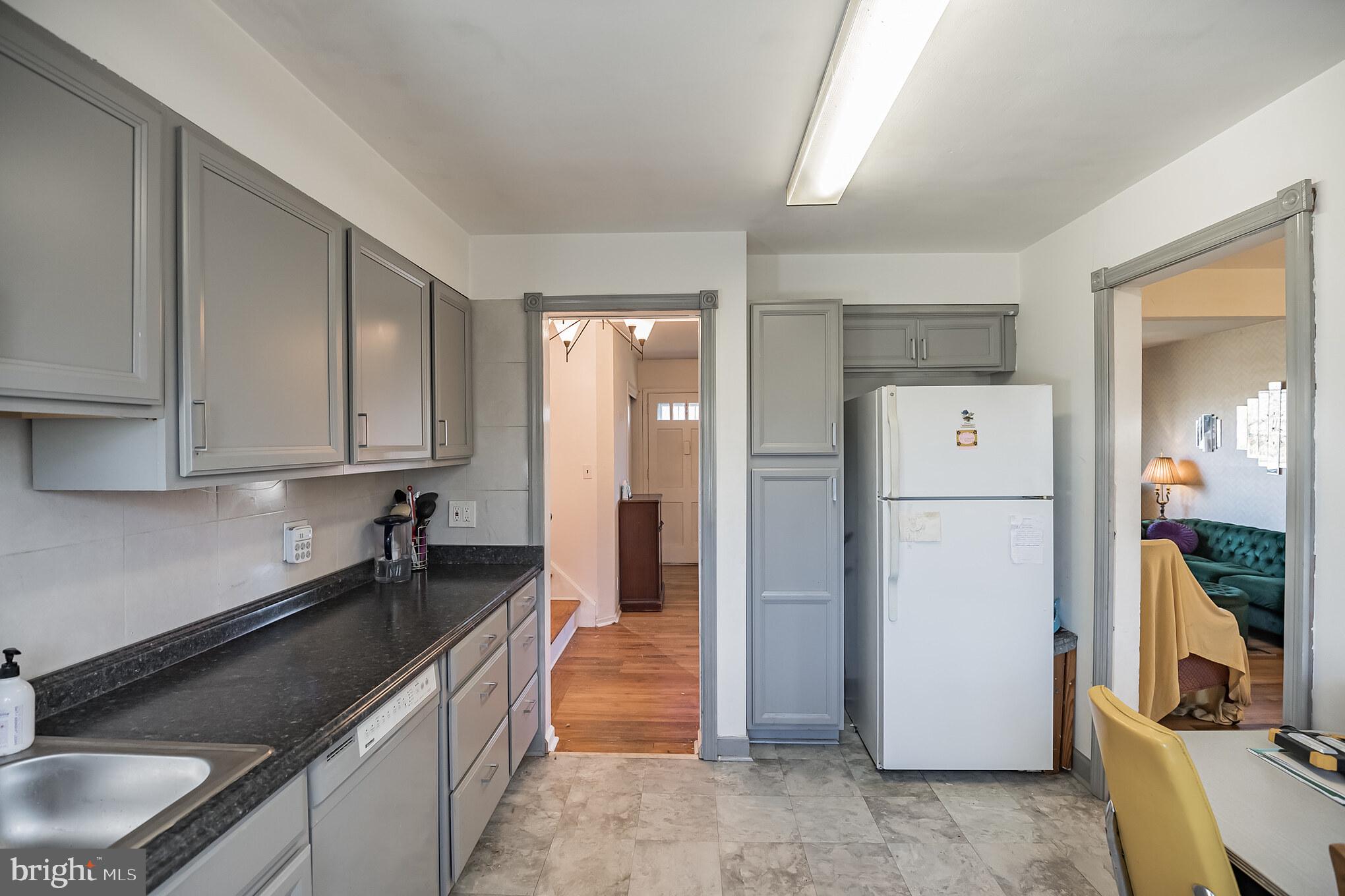 910 Woodlane Road Mount Holly, NJ 08060 - Photo 12 of 27 a kitchen with refrigerator and cabinets