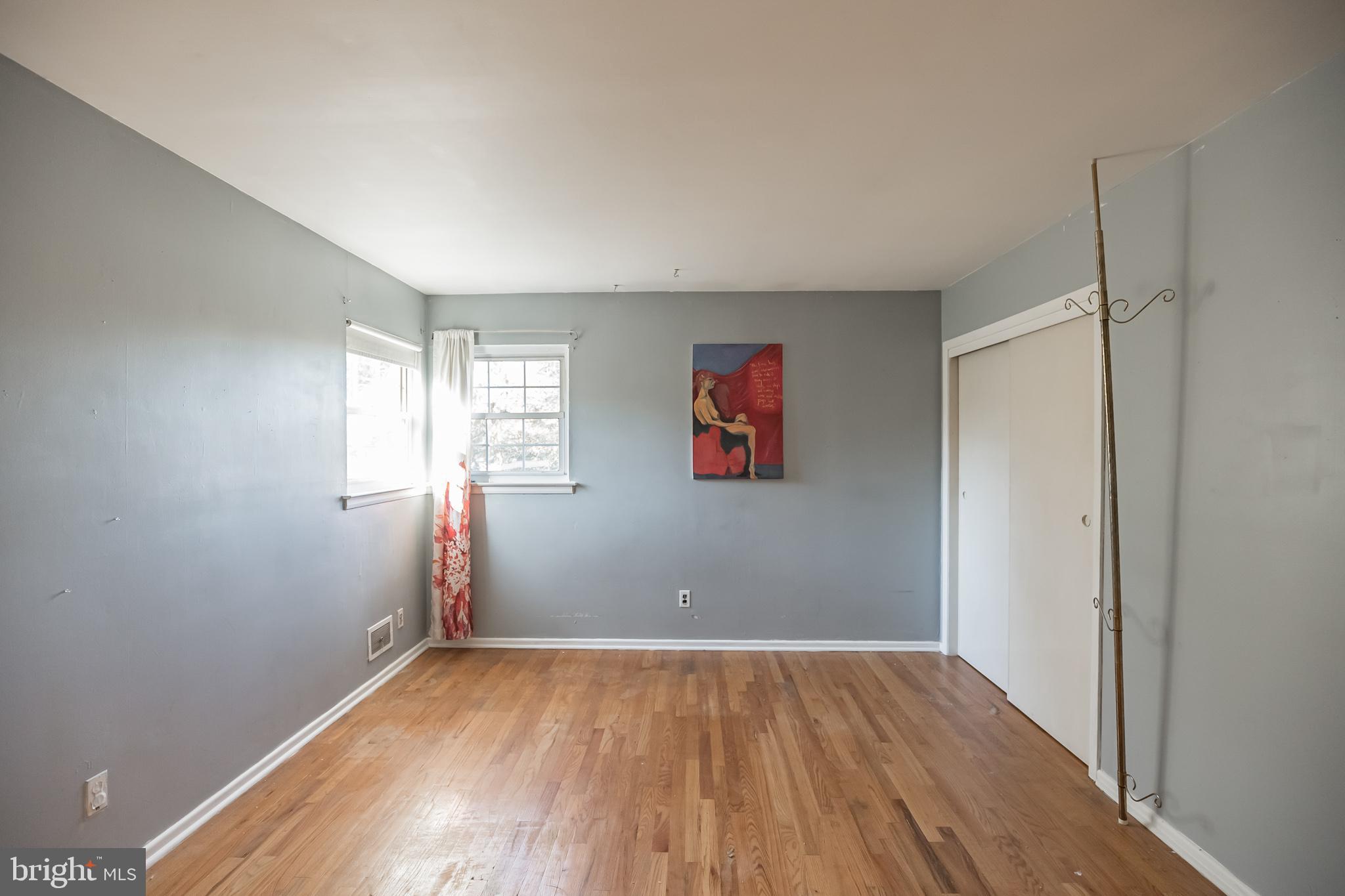 910 Woodlane Road Mount Holly, NJ 08060 - Photo 16 of 27 an empty room with wooden floor and windows
