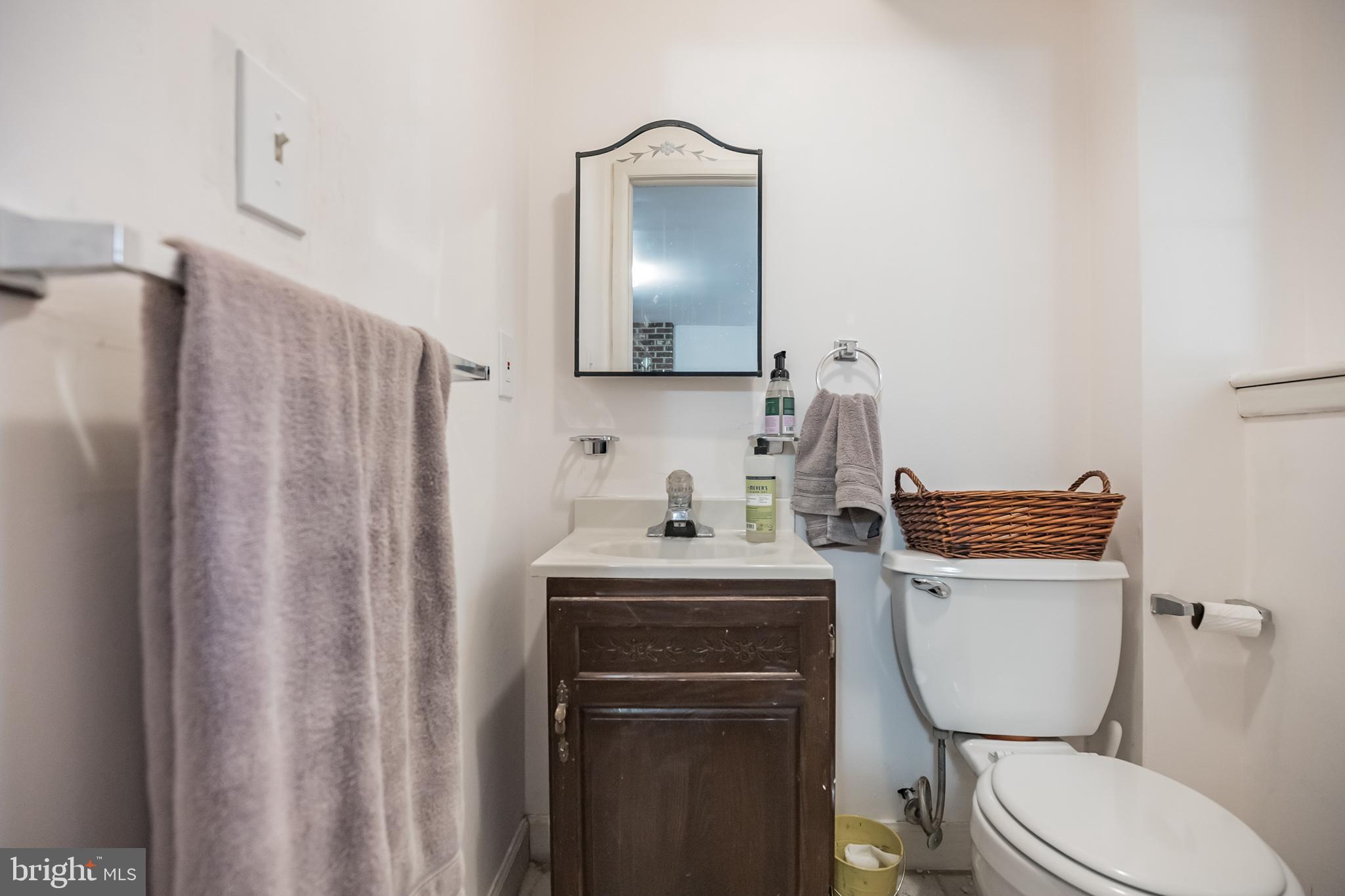 910 Woodlane Road Mount Holly, NJ 08060 - Photo 24 of 27 a bathroom with a toilet a sink and mirror