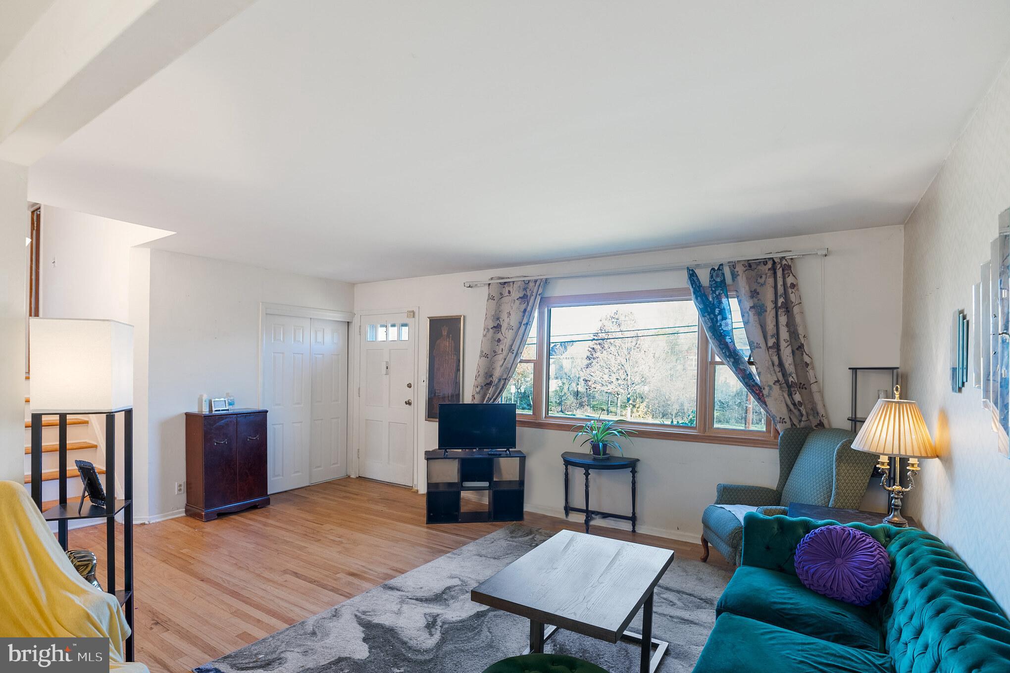 910 Woodlane Road Mount Holly, NJ 08060 - Photo 7 of 27 a living room with furniture a lamp a rug and a window
