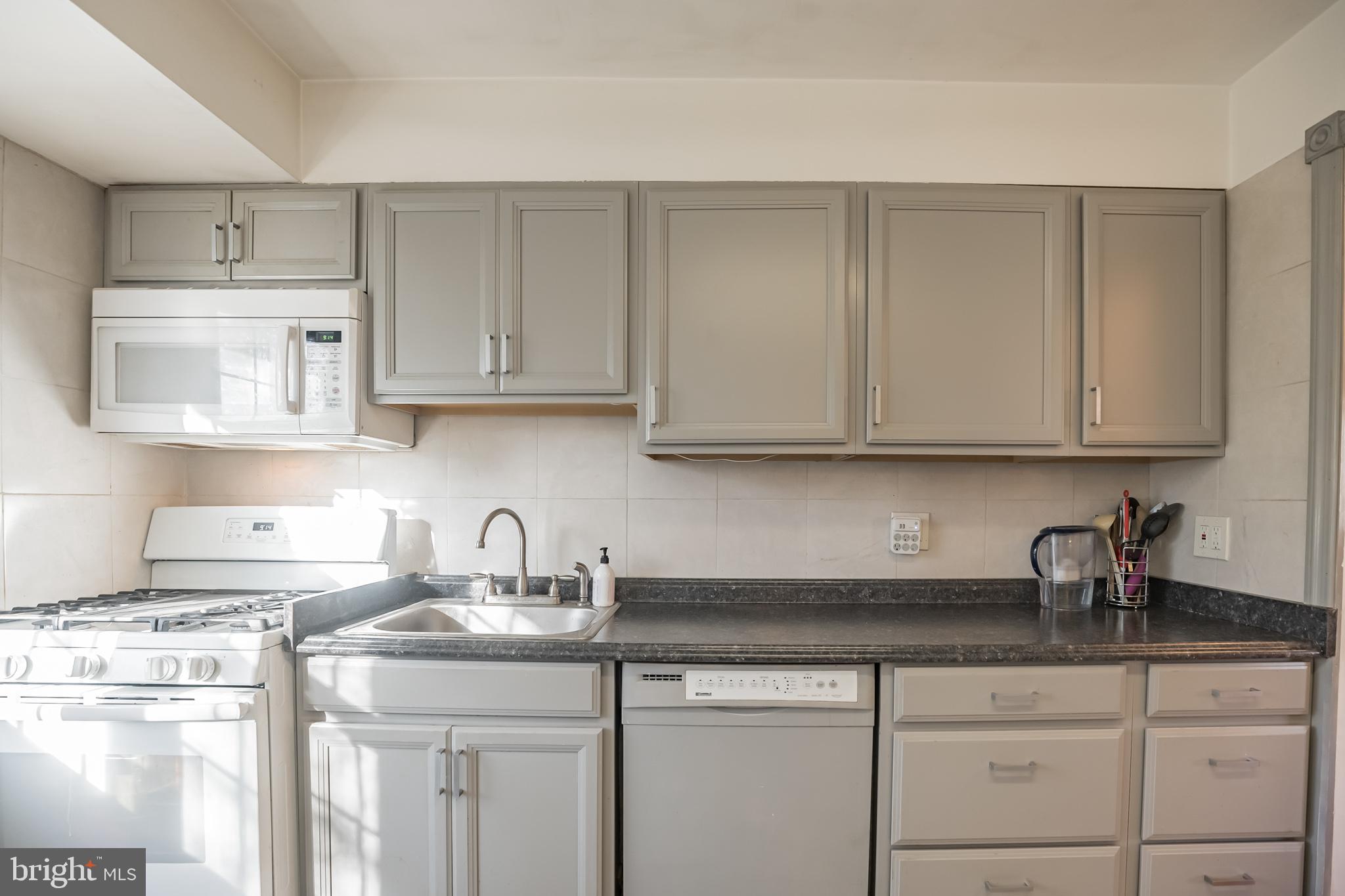 910 Woodlane Road Mount Holly, NJ 08060 - Photo 10 of 27 a kitchen with white cabinets and a sink