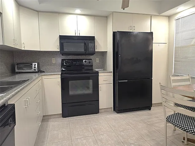 a kitchen with a refrigerator stove and microwave