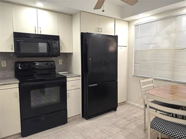 a dining room with furniture a chandelier and window