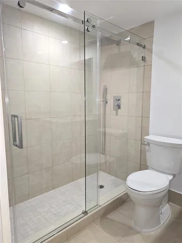 a bedroom with a bed and a chair