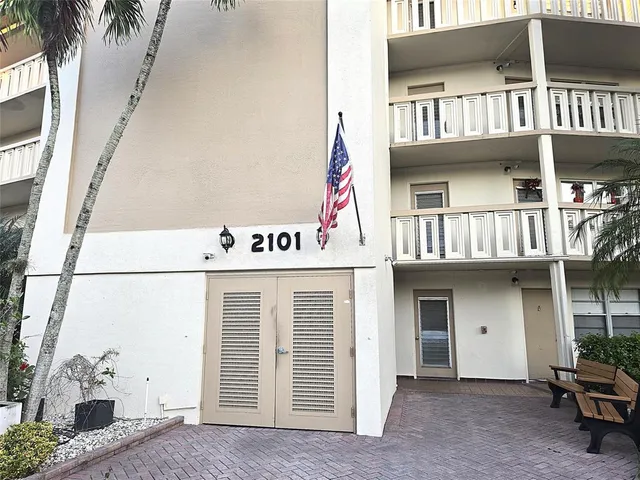 an aerial view of house with yard lake and ocean view