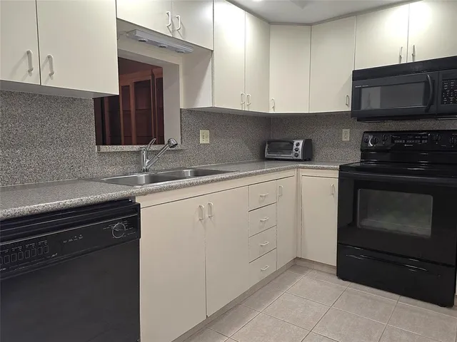 a kitchen with stainless steel appliances granite countertop a stove a microwave and oven