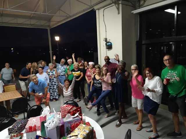a group of people sitting in front of retail shop