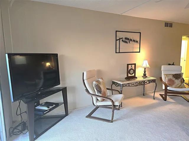 a kitchen with stainless steel appliances granite countertop a refrigerator a sink a stove a microwave and island