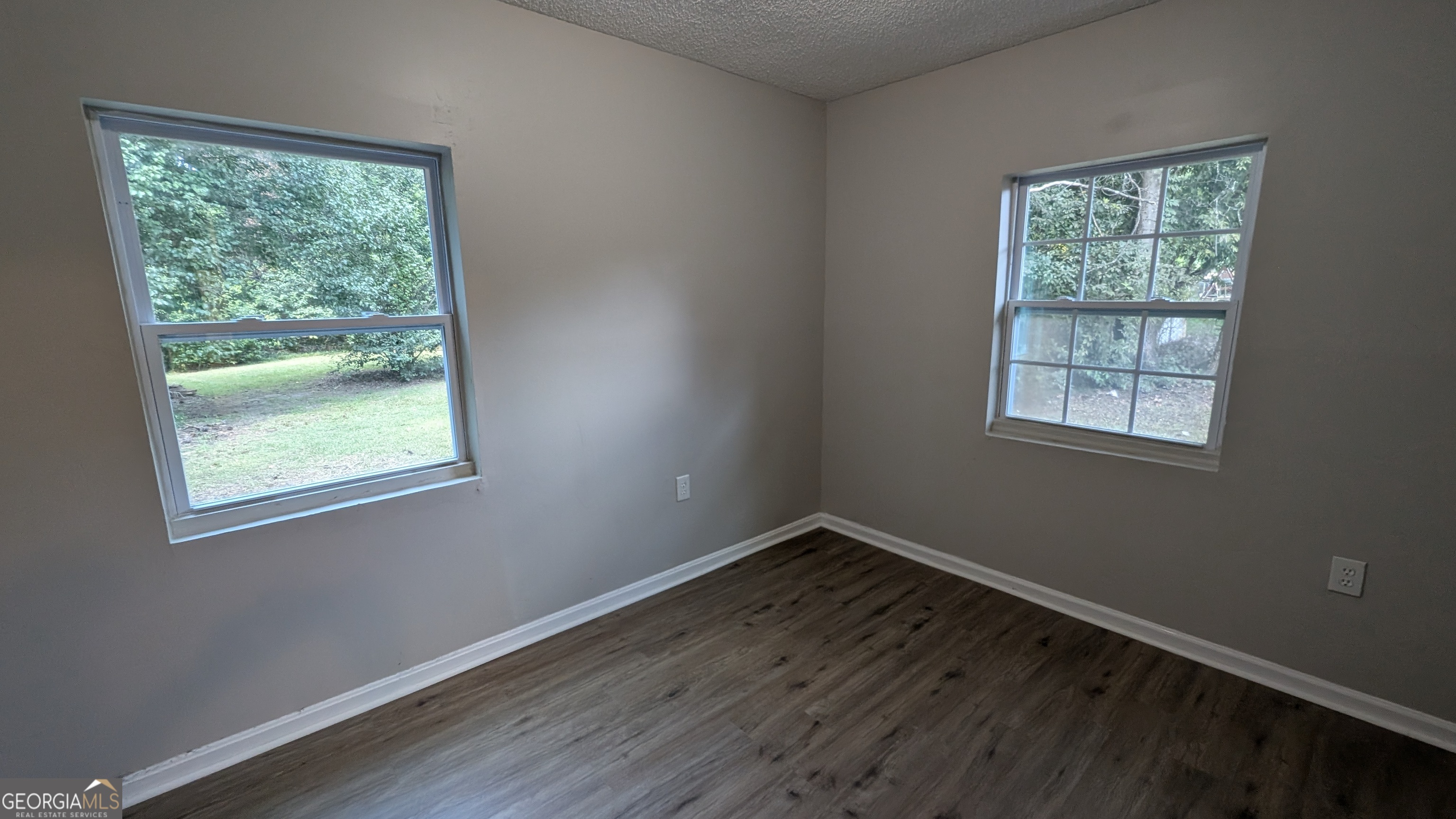 402 Johns Road Warner Robins, GA 31093 - Photo 8 of 8 a view of a room with wooden floor and windows