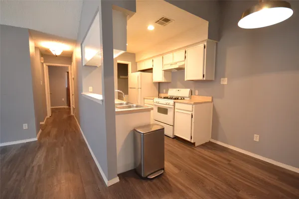 a view of a kitchen with wooden floor
