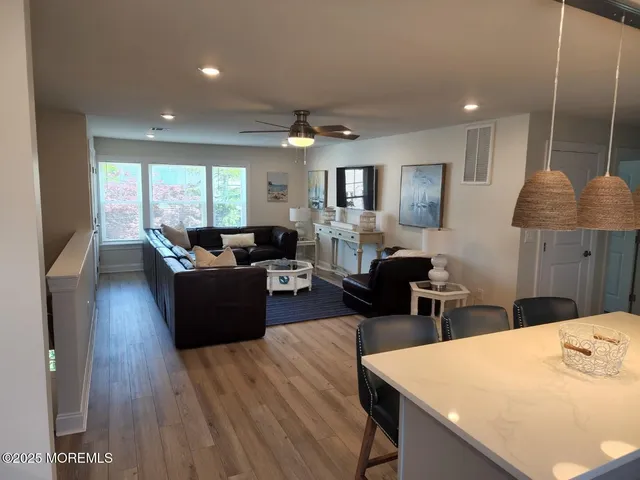 a living room with furniture window and wooden floor
