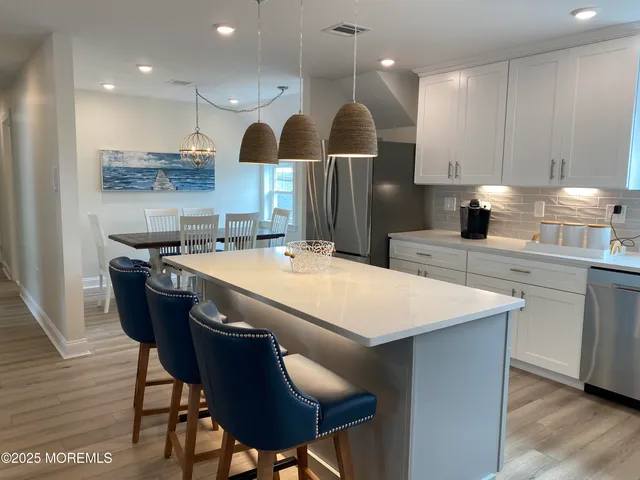a large kitchen with a table and chairs