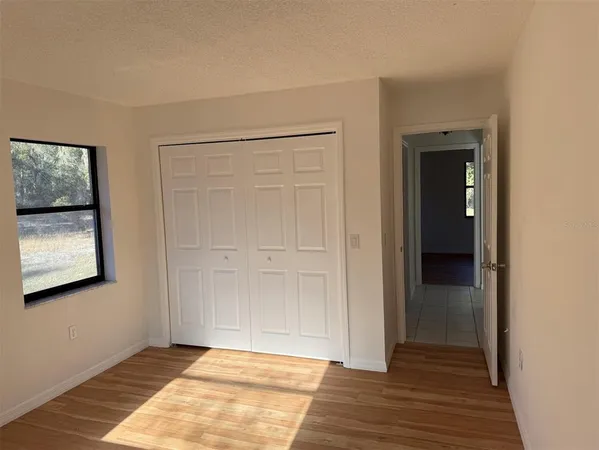a view of an empty room and wooden floor
