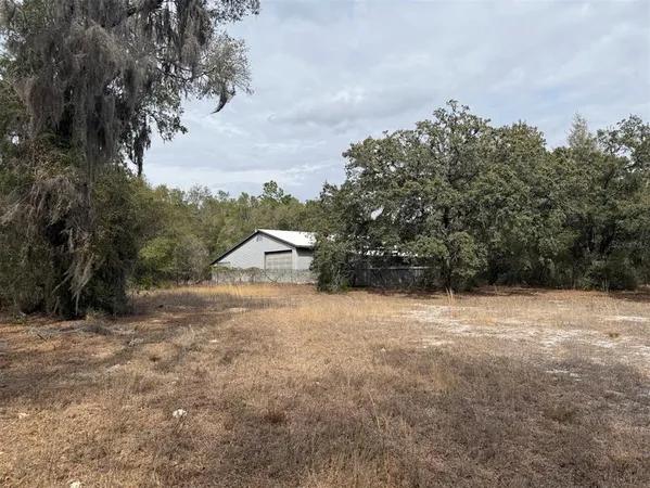 a backyard of a house with large trees