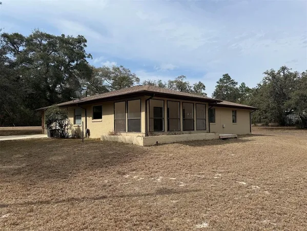 a front view of a house with a garden and yard