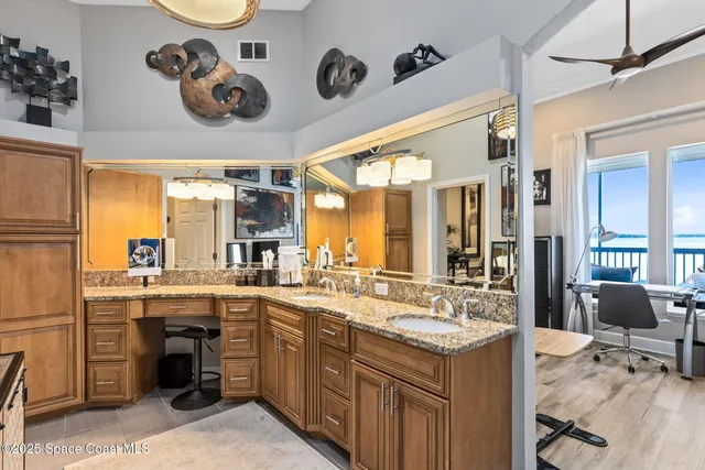 a large white kitchen with a sink and cabinets