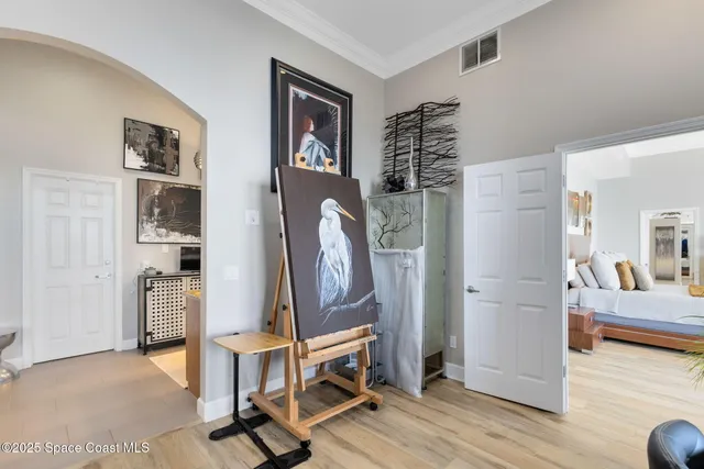 a view of hall way with furniture and wooden floor