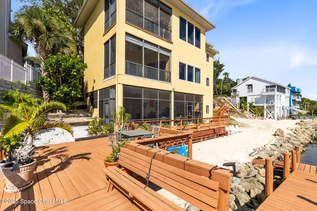 a view of a house with swimming pool and sitting area