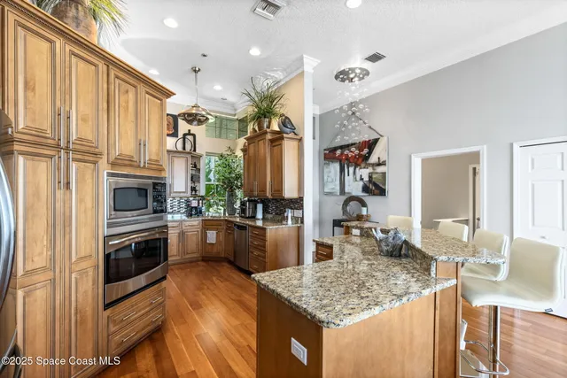 a kitchen with stainless steel appliances granite countertop a stove oven and a refrigerator
