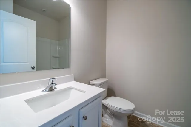 a bathroom with a sink toilet and a mirror