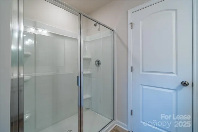 a bathroom that has a glass shower door