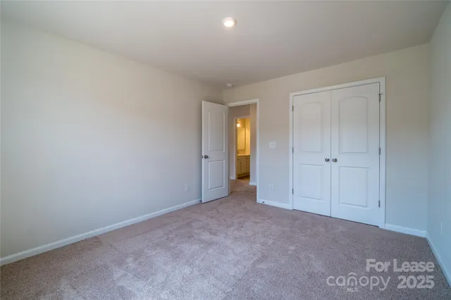 a view of an empty room and closet area