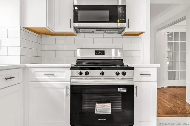 a stove top oven sitting inside of a kitchen