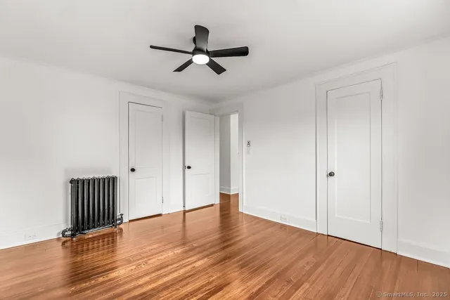 a view of a room with wooden floor and front door