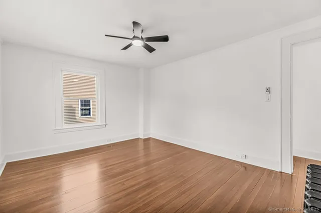 a view of a room with wooden floor and windows