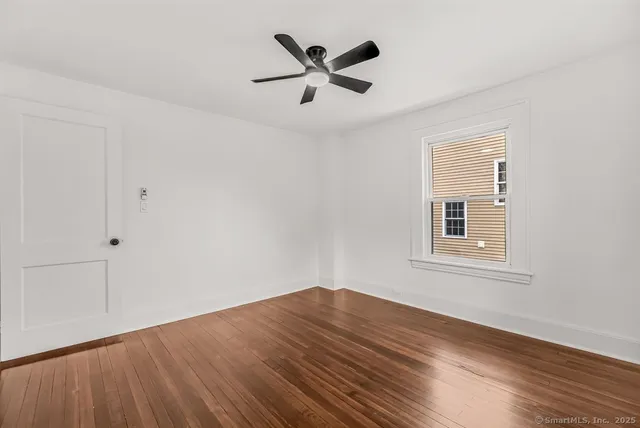 wooden floor in an empty room with a window