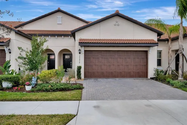 a front view of a house with a yard and garage