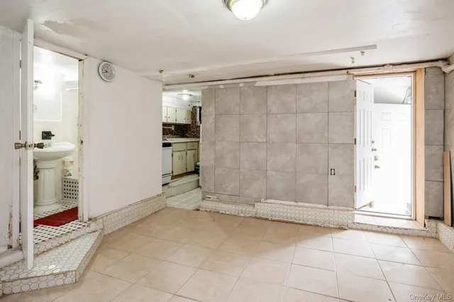 a view of empty room with wooden floor and cabinet